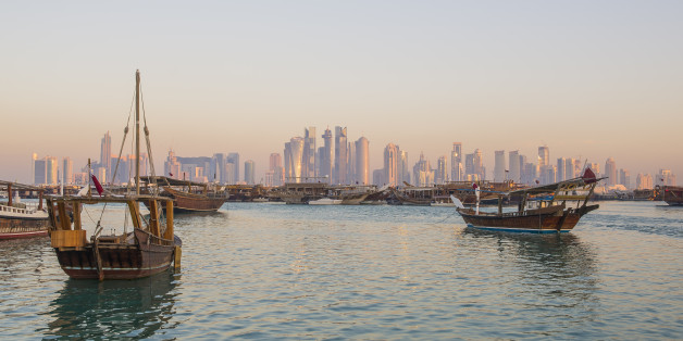 Traditional boats ( Dhows ) with background of Doha skyline , Qatar