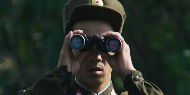 SINUIJU, NORTH KOREA - OCTOBER 23: A North Korean soldier uses a telescope as he patrols along the banks of the Yalu River in the North Korean town of Sinuiju, opposite the Chinese border city of Dandong October 23, 2006 in Sinuiju, Democratic People's Republic of Korea. U.S. Secretary of State, Condoleezza Rice has expressed doubts on North Korea's intentions to end its nuclear tests. (Photo by Cancan Chu/Getty Images)