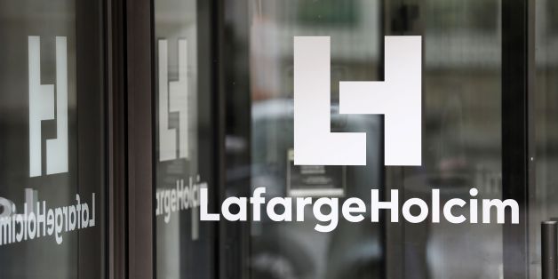 A picture taken on March 9, 2017, in Paris, shows a logo at an entrance of the French headquarters of LafargeHolcim, a group created in 2015 by the merger of French cement manufacturer Lafarge and its Swiss counterpart Holcim.French-Swiss group LafargeHolcim is ready to sell its cement to build US President Donald Trump's controversial border wall, the company's CEO said in an interview. The wall Trump promised to erect along the US-Mexico border, valued at tens of billions of dollars, is at the