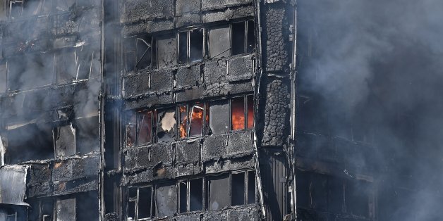 LONDON, ENGLAND - JUNE 14: Smoke continues to rise from the burning 24 storey residential Grenfell Tower block in Latimer Road, West London on June 14, 2017 in London, England. The Mayor of London, Sadiq Khan, has declared the fire a major incident as more than 200 firefighters are still tackling the blaze while at least 50 people are receiving hospital treatment. (Photo by Carl Court/Getty Images)