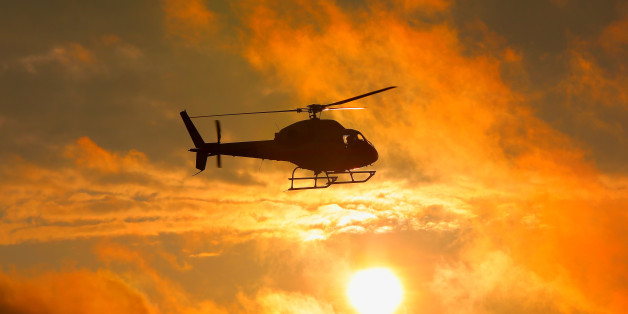 Silhouette of military helicopter at sunset