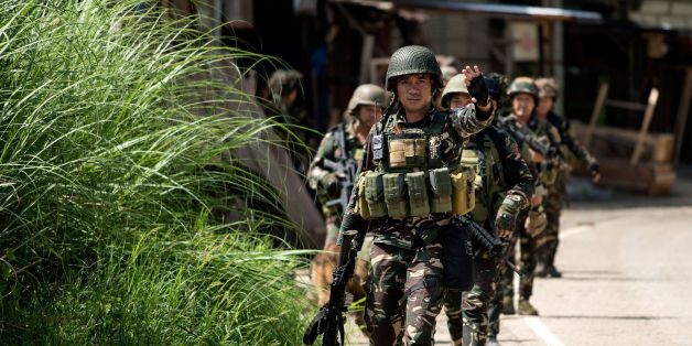 A Philippine soldier gestures while patrolling a deserted street in Marawi on the southern island of Mindanao on June 13, 2017.
Thousands of Philippine soldiers, advised by US special forces, are locked in fierce combat with hundreds of insurgents who overran Marawi city on May 23, flying black flags of the Islamic State (IS) group and using up to 2,000 civilians as human shields. / AFP PHOTO / Noel CELIS (Photo credit should read NOEL CELIS/AFP/Getty Images)