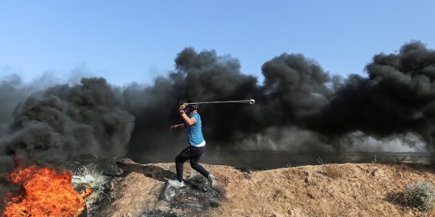 GAZA CITY, GAZA - JUNE 09 : A Palestinian protester with a slingshot clashes with the Israeli security forces during a protest against the Israeli blockade at Israeli border in eastern part of Jabalia Refugee Camp in Gaza City, Gaza on June 09, 2017. (Photo by Mustafa Hassona/Anadolu Agency/Getty Images)