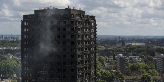 LONDON, ENGLAND - JUNE 15: Debris hangs from the blackened exterior of Grenfell Tower on June 15, 2017 in London, England. At least 17 people have been confirmed dead and dozens missing, after the 24 storey residential Grenfell Tower block in Latimer Road was engulfed in flames in the early hours of June 14. The number of fatalities are expected to rise. (Photo by Dan Kitwood/Getty Images)