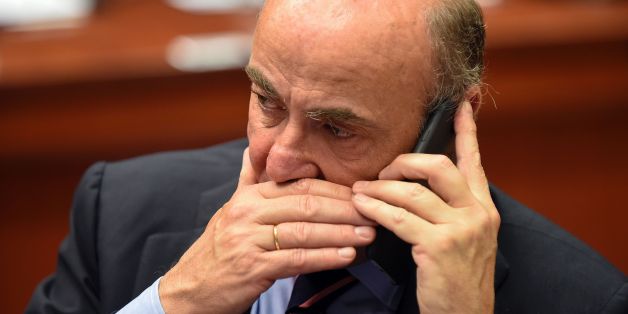Spain's Economy Minister Luis de Guindos speaks on his mobile phone prior to a session of the Economic and Financial Affairs, Council (Ecofin) with EU finance ministers on May 23, 2017 at the EU headquarters in Brussels. / AFP PHOTO / JOHN THYS (Photo credit should read JOHN THYS/AFP/Getty Images)