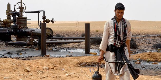 A local walks near a petroleum pumping station in El Kamour, in Tunisia's southern state of Tatatouine, on May 24, 2017, as protestors continue to stage a sit-in outside the oil and gas plant to demand for a share of the resources and employment in the sector. Since April 23, 2017, hundreds of protesters have blocked traffic on the road leading to the oilfields in Tataouine and erected tents at a sit-in outside el-Kamour, demanding the allocation of 70 percent of jobs in the petroleum sector for