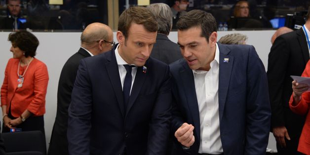 Greek Prime Minister Alexis Tsipras (R) speaks with French President Emmanuel Macron (L) during the NATO (North Atlantic Treaty Organization) summit at the NATO headquarters, in Brussels, on May 25, 2017. / AFP PHOTO / POOL / THIERRY CHARLIER (Photo credit should read THIERRY CHARLIER/AFP/Getty Images)