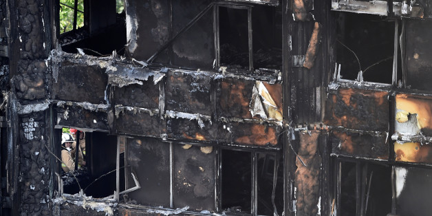 Firefighters at the Grenfell Tower block which was destroyed in a disastrous fire, in north Kensington, West London, Britain June 16, 2017. REUTERS/Hannah McKay
