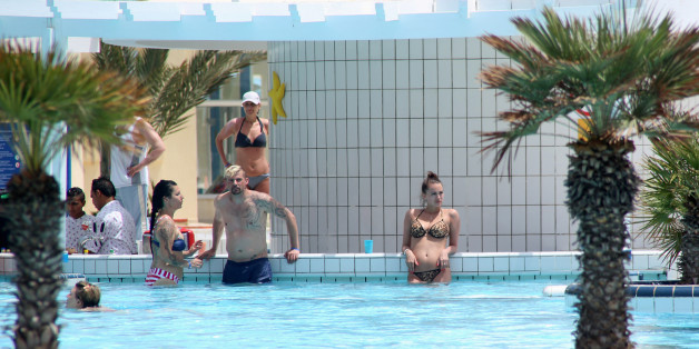 Tourists are seen inside a swimming pool at a hotel in Hammamet, Tunisia, May 27, 2016. REUTERS/Zoubeir Souissi