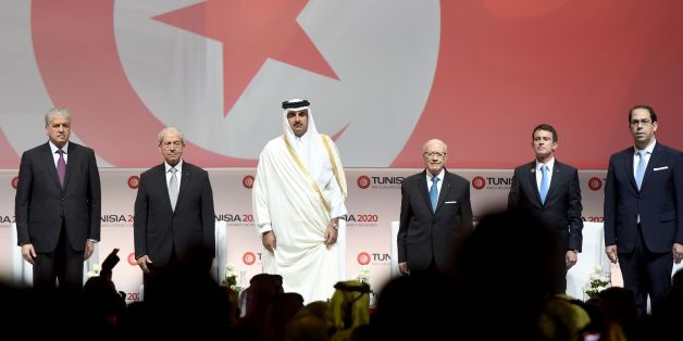 (LtoR) Algerian Prime Minister Abdelmalek Sellal: Tunisian Assembly President Mohamed Ennaceur; the Emir of Qatar, Tamim bin Hamad al-Thani; Tunisian President Beji Caid Essebsi, French Prime Minister Manuel Valls and Tunisian Prime Minister Youssef Chahed (R) stand on stage during the opening ceremony of the 'Tunisia 2020' international investment conference on November 29, 2016 in Tunis. France and Qatar promised billions of dollars of financial support to Tunisia at the launch Tuesday of a co