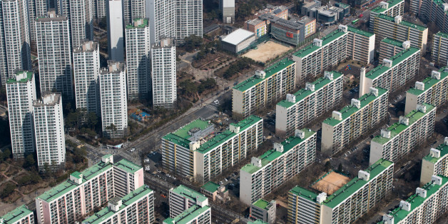 Residential apartment buildings are seen from the observation deck of the Lotte Corp. World Tower in Seoul, South Korea, on Thursday, March 16, 2017. After almost seven years of planning and 4 trillion won ($3.6 billion) in spending, Lotte Group is preparing to unwrap its tower to the public. The building boasts some record-setting amenities: highest glass floor at the top of a building and highest swimming pool. Photographer: SeongJoon Cho/Bloomberg via Getty Images