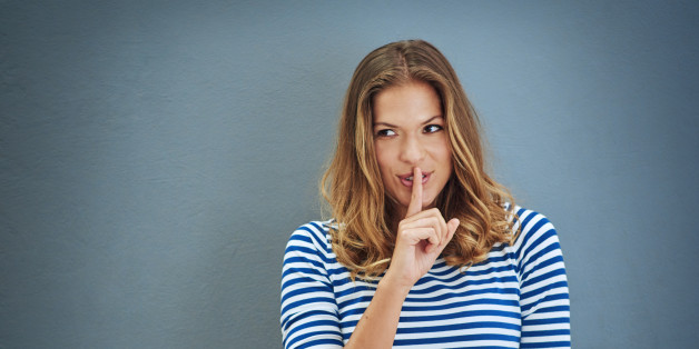 Studio shot of a young woman covering her lips with her finger against a gray backgroundhttp://195.154.178.81/DATA/i_collage/pi/shoots/806302.jpg
