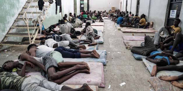 TOPSHOT - Illegal immigrants are seen at a detention centre in Zawiyah, 45 kilometres west of the Libyan capital Tripoli, on June 17, 2017.
The Libyan coastguard has rescued more than 900 African and Asian migrants attempting to reach Europe, a navy spokesman said. / AFP PHOTO / Taha JAWASHI (Photo credit should read TAHA JAWASHI/AFP/Getty Images)