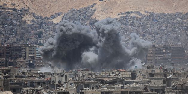 Smoke billows following a reported air strike in the rebel-held parts of the Jobar district, on the eastern outskirts of the Syrian capital Damascus, on June 18, 2017. / AFP PHOTO / AMER ALMOHIBANY (Photo credit should read AMER ALMOHIBANY/AFP/Getty Images)