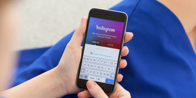 Alushta, Russia - December 3, 2014: Woman holding a iPhone 6 Space Gray with social networking service Instagram on the screen. iPhone 6 was created and developed by the Apple inc.