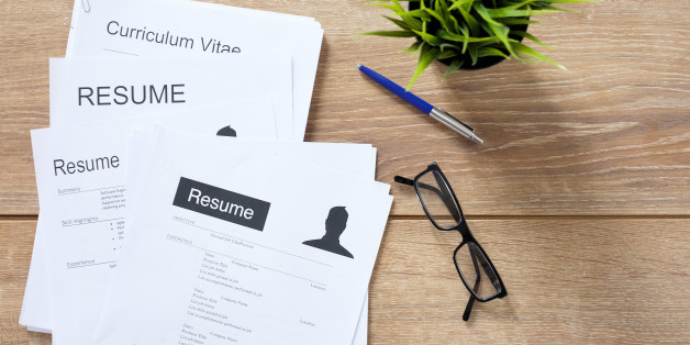 Resume applications on wooden desk ready to be reviewed