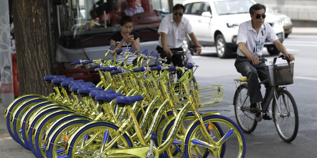 BEIJING, CHINA - JUNE 08: Golden sharing bikes of a bike-sharing service are available on the street at Chaoyang District on June 8, 2017 in Beijing, China. Golden sharing bikes equipped with wireless charge modules could charge mobile phones in Beijing. (Photo by VCG/VCG via Getty Images)