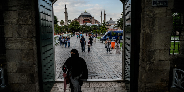 TOPSHOT - A woman walks through a gate of the Blue mosque square before breaking time as Hagia Sofia is seen on the background on June 6, 2016 in Istanbul, during the first day of the holy month of Ramadan.
More than a billion Muslims observed the start of Ramadan on May 6 but in the besieged cities of Syria and Iraq residents struggled to mark the holy month. Marking the divine revelation received by Prophet Mohammed, the month sees Muslim faithful abstain from eating, drinking, smoking and having sex from dawn to dusk. They break the fast with a meal known as iftar and before dawn have a second opportunity to eat and drink during suhur. The month is followed by the Eid al-Fitr festival.
/ AFP / OZAN KOSE (Photo credit should read OZAN KOSE/AFP/Getty Images)