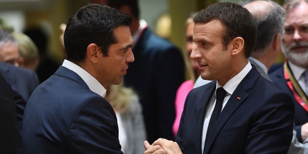 French President Emmanuel Macron (R) speaks with Greek Prime Minister Alexis Tsipras as he attends his first European Council in Brussels, on June 22, 2017. / AFP PHOTO / EMMANUEL DUNAND (Photo credit should read EMMANUEL DUNAND/AFP/Getty Images)