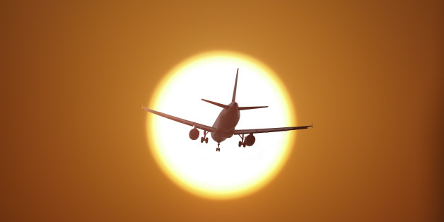 Airplane flying in the sunset
