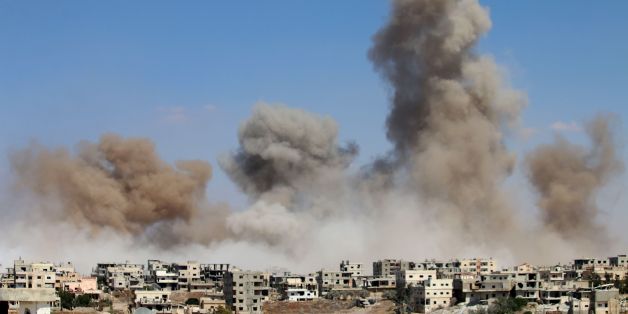 TOPSHOT - Smoke rises following a reported air strike on a rebel-held area in the southern Syrian city of Daraa, on June 22, 2017. / AFP PHOTO / Mohamad ABAZEED (Photo credit should read MOHAMAD ABAZEED/AFP/Getty Images)