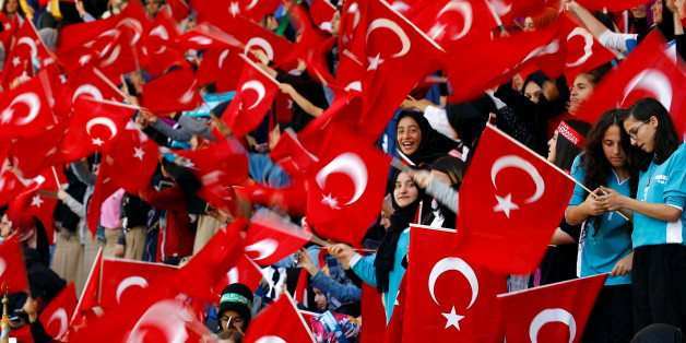 Imam Hatip religious school students wave national flags as they wait for arrival of Turkish President Tayyip Erdogan during a graduation ceremony in Istanbul, Turkey, May 26, 2017. REUTERS/Murad Sezer