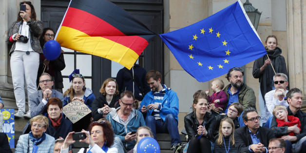 Participants of the Pro-Europe "Pulse of Europe" movement hold European Union and German flags during a protest at Gendarmenmarkt square in Berlin, Germany, April 2, 2017. REUTERS/Fabrizio Bensch