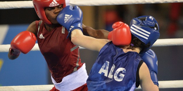 Algeria's Souhila Bouchene celebrates with her gold medal after winning the women's boxing (48-51kg) final at the 11th Africa Games in Brazzaville on September 12, 2015. AFP PHOTO / MONIRUL BHUIYAN (Photo credit should read Monirul Bhuiyan/AFP/Getty Images)