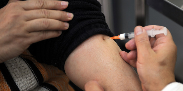An Algerian doctor vaccinates a man against the H1N1 flu at 'Beni Mesouss' hospital on December 30, 2009 in Algiers. Algeria launched a national swine flu vaccination campaign on Wednesday. The vaccination campaign will be carried out in six phases to cover public and private health personnel, pregnant women, staff involved in core and strategic activities, all patients suffering from chronic diseases, children and teenagers over six months to 14 years of age, announced the Ministry of Health.