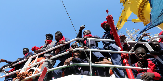 Migrants wait to disembark from the Vos Hestia ship as they arrive at the Crotone harbour, after being rescued by a "Save the Children" crew in the Mediterranean sea off the Libya coast, in Crotone, Italy June 21, 2017. REUTERS/Stefano Rellandini