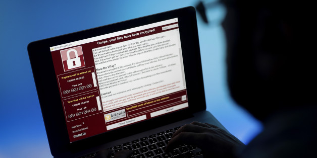 A lock screen from a cyber attack warns that data files have been encrypted on a laptop computer in this arranged photo in London, U.K., on Monday, May 15, 2017. Governments and companies around the world began to gain the upper hand against the first wave of an unrivaled global cyberattack, even as the assault was poised to continue claiming victims this week. Photographer: Simon Dawson/Bloomberg via Getty Images