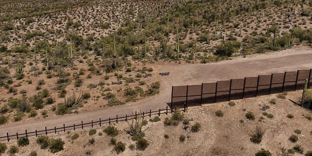 View of the metal fence along the border in Sonoyta, Sonora state, northern Mexico, between the Altar desert in Mexico and the Arizona desert in the United States, on March 27, 2017.Threatened species like the Sonoran pronghorn or desert bighorn sheep freely cross the border between Mexico and the United States in protected biospheres, but the construction of US President Donald Trump's wall will block their movement in these desert valleys and could drive them to extinction. / AFP PHOTO / PEDRO
