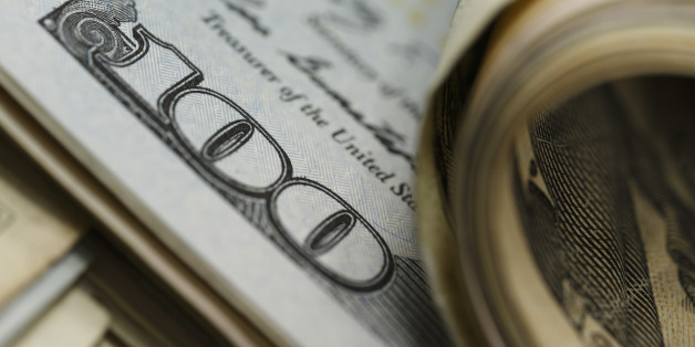 Closeup of curled and flat $100 bills ; shot with very shallow depth of field
