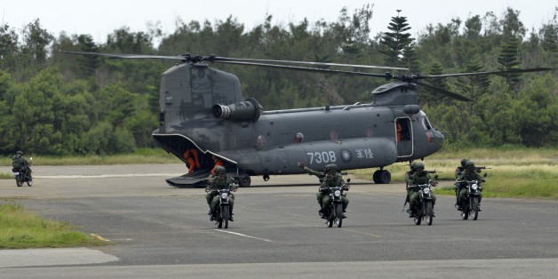 Armed Taiwanese soldiers ride on motorcycles next to a US-made CH-47 helicopter during the 'Han Kuang' (Han Glory) life-fire drill, some 7 kms (4 miles) from the city of Magong on the outlying Penghu islands on May 25, 2017.
Taiwan forces conducted live-fire war games in its biggest annual military exercise on May 25, presided by President Tsai Ing-wen, as the island faces growing threat from its cross-strait rival China. / AFP PHOTO / SAM YEH (Photo credit should read SAM YEH/AFP/Getty Images)