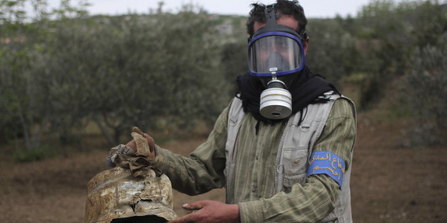 A Civil Defence member carries a damaged canister in Ibleen village from what activists said was a chlorine gas attack, on Kansafra, Ibleen and Josef villages, Idlib countryside May 3, 2015. REUTERS/Abed Kontar