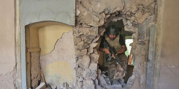 A member of the Iraqi Counter-Terrorism Service (CTS) walks through the rubble and the broken wall of a damaged building during the advance towards the Grand Mosque of Nuri in the Old City of Mosul on June 29, 2017, as the offensive by Iraqi forces continues to retake the last district still held by the Islamic State (IS) group. / AFP PHOTO / AHMAD AL-RUBAYE (Photo credit should read AHMAD AL-RUBAYE/AFP/Getty Images)