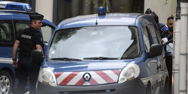 French gendarmes prepare to escort a vehicle carrying Murielle Bolle (not pictured) outside the courthouse of Dijon on June 29, 2017 where she is being heard for complicity in the murder of the four-year-old Gregory Villemin in 1984.Bolle is the sister in law of Bernard Laroche, who was charged with the murder of Gregory Villemin, based on evidence she gave when she was a teenager. Four-year-old Gregory Villemin was found, his hands and feet bound, drowned in the Vologne river in the Vosges moun