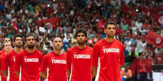RADES, TUNISIA - AUGUST 29: Tunisia's players sing national anthem before the 2015 FIBA Afrobasket Championship semi finals basketball match between Tunisia and Angola at Omnisport Hall in Rades, Tunisia on August 29, 2015. (Photo by Amine Landoulsi/Anadolu Agency/Getty Images)