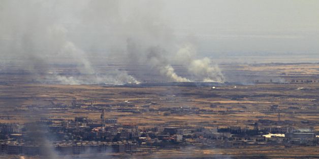 A picture taken from the Israeli-occupied Golan Heights shows smoke billowing from the Syrian side of the border on June 26, 2017.
Israeli forces fired on Syria after several projectiles from the war-torn country hit the occupied Golan Heights, the army said, in the second such exchange in three days. / AFP PHOTO / JALAA MAREY (Photo credit should read JALAA MAREY/AFP/Getty Images)