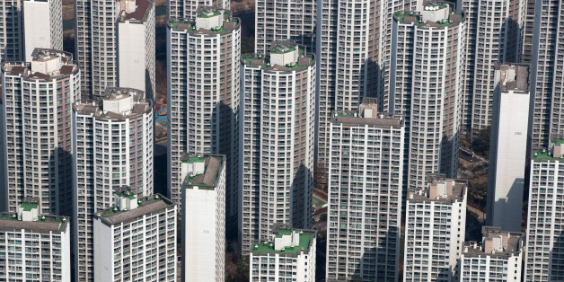 Residential apartment buildings are seen from the observation deck of the Lotte Corp. World Tower in Seoul, South Korea, on Thursday, March 16, 2017. After almost seven years of planning and 4 trillion won ($3.6 billion) in spending, Lotte Group is preparing to unwrap its tower to the public. The building boasts some record-setting amenities: highest glass floor at the top of a building and highest swimming pool. Photographer: SeongJoon Cho/Bloomberg via Getty Images