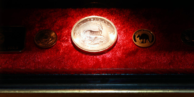 Gold coins dispensed from the first gold-plated automated teller machine (ATM) in Europe sit on display at the Westin Palace Hotel, in Madrid, Spain, on Wednesday, Sept. 29, 2010. The machine, which features cutting-edge technology, dispenses 1g, 5g and 10g gold bars and also dispenses gold coins bearing designs such as Krugerrand, Maple Leaf and Kangaroo, which are sold in gift boxes at real-time prices, organizers said in the media release. Photographer: Liesa Johannssen/Bloomberg via Getty Images