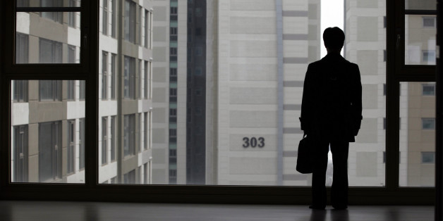 Kim Keon-hoon, a worker with Byucksan Engineering & Construction, looks out through the window from his empty two-bathroom, four-bedroom apartment before an interview with Reuters, in the middle class suburb in Goyang, north of Seoul April 1, 2013. Kim says he was forced to buy an unsold 800 million won ($716,400) apartment, built by his employer in 2008, as the company teetered on the edge of bankruptcy. Five years after the global financial crisis, South Korean construction workers are feeling