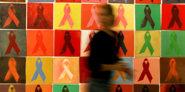 A woman walks past an artwork by Athina Robie depicting Aids awareness ribbons at an exhibition inside Athens' Syntagma metro station marking World Aids Day December 1, 2005. The number of people living with HIV, the virus that causes AIDS, had reached its highest level ever in 2005 at an estimated 40.3 million people, UNAIDS Executive Director Peter Piot said. REUTERS/Yiorgos Karahalis Pictures of the Month December 2005