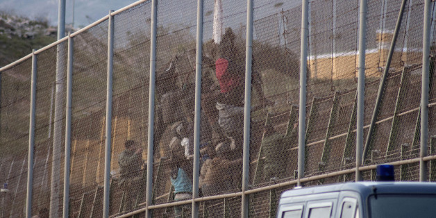 African migrants scale back over a border fence between Morocco and Spain's north African enclave Melilla after a failed attempt to cross into Spanish territory March 28, 2014. Spain has more than doubled the strength of security forces at Melilla, after about 500 people stormed its fences in the biggest border rush for years earlier this month. Immigrants from all over Africa regularly dare the razor-wire fences of Spanish enclaves Ceuta and Melilla, which are surrounded by Moroccan territory a