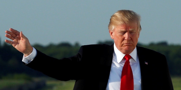 U.S. President Donald Trump waves as he boards Air Force One at Morristown municipal airport, New Jersey, U.S., en route back to Washington after a weekend at the Trump National Golf Club in Bedminster July 3, 2017. REUTERS/Yuri Gripas