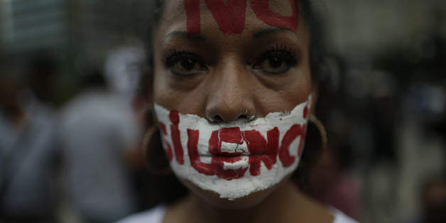 MEXICO CITY, MEXICO - JUNE 15: A woman with a writing on her face that reads 'no to silence' looks at the camera during a demonstration to end violence against journalists in Mexico outside the Palacio de Bellas Artes on June 15, 2017 in Mexico City, Mexico. Today marks one month since the assassination of Mexican journalist Javier Valdez Cardenas which shook the international press community. (Photo by Miguel Tovar/LatinContent/Getty Images)