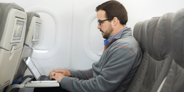 A man uses his laptop to test a new high speed inflight Internet service named Fli-Fi while on a special JetBlue media flight out of John F. Kennedy International Airport in New York December 11, 2013. Wi-Fi in the sky is taking off, promising much better connections for travelers and a bonanza for the companies that sell the systems. With satellite-based Wi-Fi, Internet speeds on jetliners are getting lightning fast. And airlines are finding that travelers expect connections in the air to rival