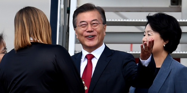 The President of South Korea Moon Jae-In (C) and his wife Kim Jeong-suk arrive at the airport in Hamburg, northern Germany on July 6, 2017 to attend the G20 meeting.Donald Trump arrived for high-stakes visit to Europe on July 5, landing in Poland ahead of his first G20 summit in Hamburg and a closely-watched meeting with Russian President Vladimir Putin. / AFP PHOTO / PATRIK STOLLARZ (Photo credit should read PATRIK STOLLARZ/AFP/Getty Images)