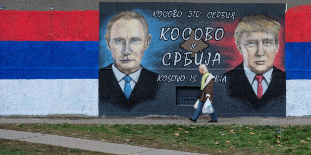 A woman walks past a mural of U.S. president-elect Donald Trump and Russian President Vladimir Putin in Belgrade, Serbia, December 4, 2016. The text on the mural reads in Russian, Serbia and English "Kosovo is Serbia". REUTERS/Marko Djurica