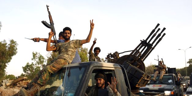 Members of the Salah Bou-Haliqa brigade, loyal to the country's east strongman Khalifa Haftar's self-styled Libyan National Army, celebrate as they arrive in the eastern city of Benghazi after seizing the central al-Jufra area from the Benghazi Defence Brigades coalition, a rival to Haftar's forces on June 5, 2017. / AFP PHOTO / Abdullah DOMA (Photo credit should read ABDULLAH DOMA/AFP/Getty Images)